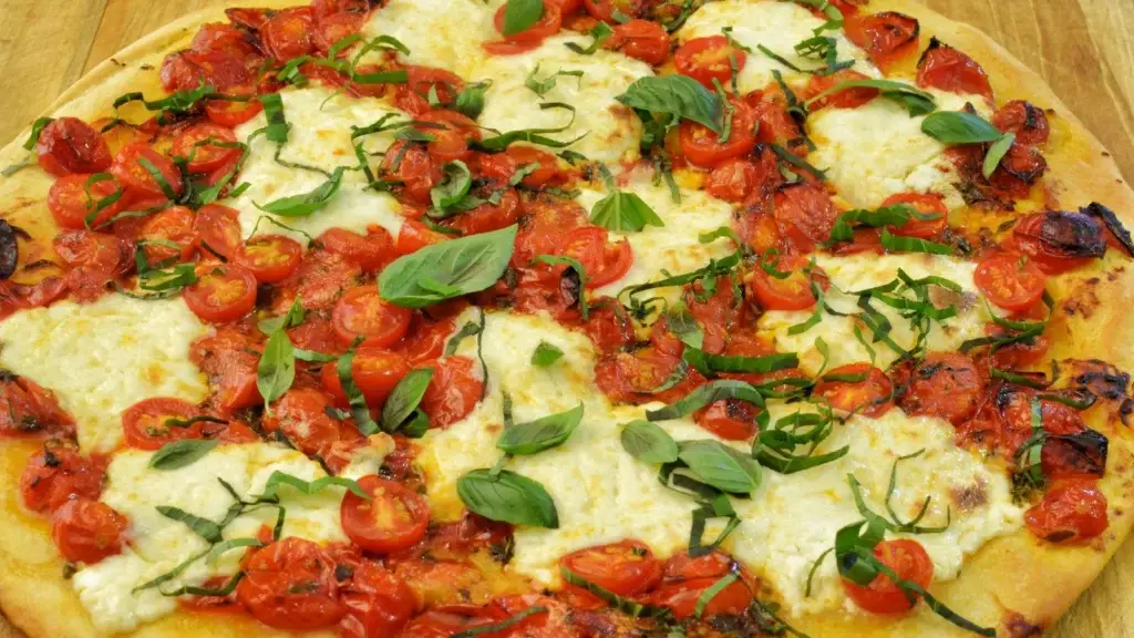 Homemade margherita pizza with mozzarella, cherry tomatoes and basil